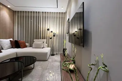 a living room with a white couch and a table at Casa The Address - By AppartAli in Casablanca