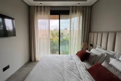 a bedroom with a bed and a large window at Casa The Address - By AppartAli in Casablanca