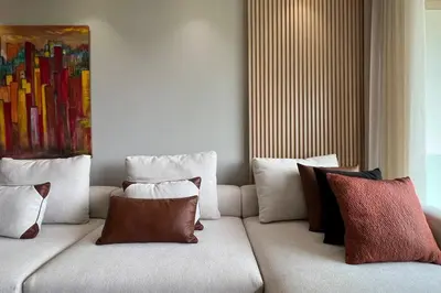 a couch with pillows on it in a room at Casa The Address - By AppartAli in Casablanca