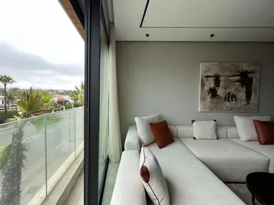 a living room with a white couch and a window at The Address to Ocean - By AppartAli in Casablanca