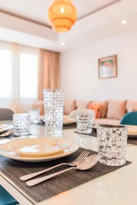 a dining room table with a plate and silverware at Appartement Cosy et central in Casablanca