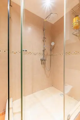 a shower with a glass door in a bathroom at Appartement Cosy et central in Casablanca