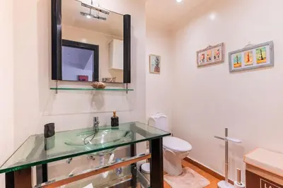 a bathroom with a sink and a toilet and a mirror at Appartement Cosy et central in Casablanca