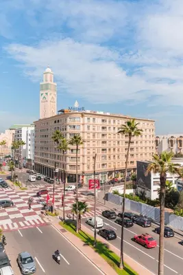 a large building with a clock tower in a city at Appartement Cosy et central in Casablanca