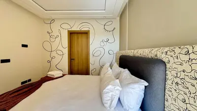 a bedroom with a bed with white pillows on it at Casa Stop Spot - AppartAli in Casablanca