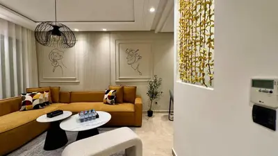 a living room with a couch and a table at Casa Stop Spot - AppartAli in Casablanca