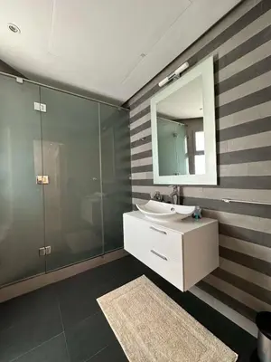 a bathroom with a sink and a mirror at Sea and Marina View - By AppartAli in Casablanca