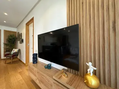a living room with a large flat screen tv at Sea and Marina View - By AppartAli in Casablanca