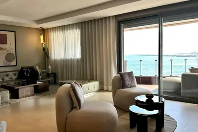 a living room with a view of the ocean at State of Peace in Marina - By AppartAli in Casablanca