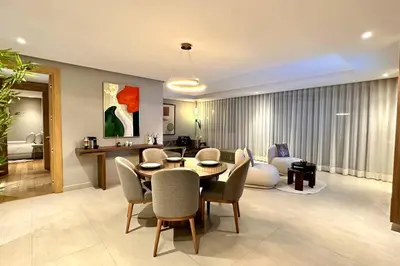 a living room with a table and chairs and a couch at State of Peace in Marina - By AppartAli in Casablanca