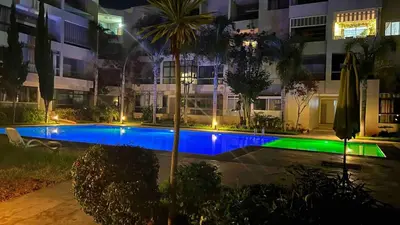 a swimming pool in front of a building at night at Best appartement pools view at Mansouria in Pont Blondin
