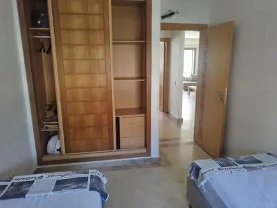 a bedroom with a closet with a large mirror at Best appartement pools view at Mansouria in Pont Blondin