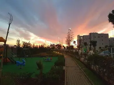 a park with children playing on a playground at sunset at Best appartement pools view at Mansouria in Pont Blondin