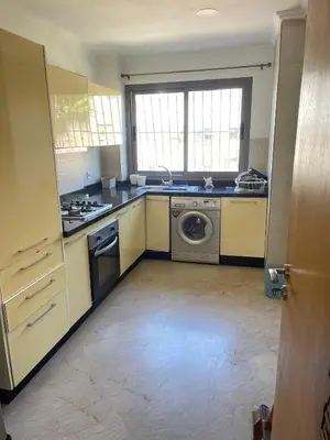 a kitchen with a sink and a washing machine at Best appartement pools view at Mansouria in Pont Blondin