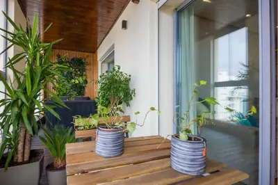 a porch with potted plants on a balcony at La Terrazza at Marina - By AppartAli in Casablanca