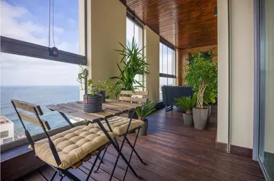 a dining room with a table and a view of the ocean at La Terrazza at Marina - By AppartAli in Casablanca