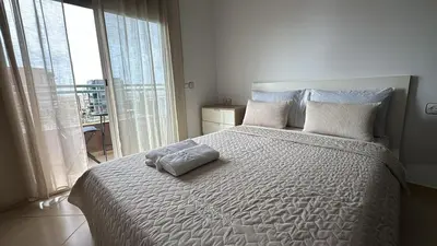 a bedroom with a large bed with white sheets and pillows at Apartement en Wifak Soleil, calme et sécurité in Temara