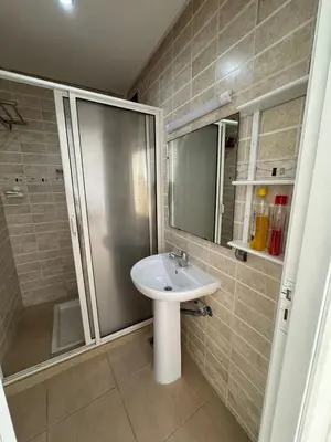 a bathroom with a sink and a shower at Apartement en Wifak Soleil, calme et sécurité in Temara