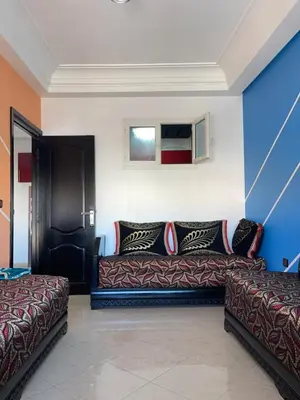 a living room with a couch and a bed at Furnished apartment in the middle of the city in Casablanca