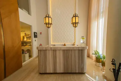 a room with a counter with three lights above it at Dally Apart Hotel in Rabat