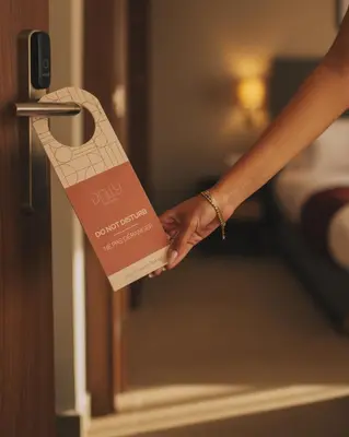a person holding a hotel door handle with a passport at Dally Apart Hotel in Rabat