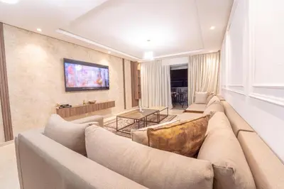 a living room with a large couch and a table at Modern apartment with pool view Tamaris in Tamaris