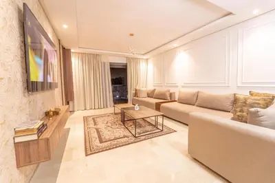 a living room with a couch and a table at Modern apartment with pool view Tamaris in Tamaris
