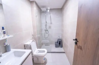 a bathroom with a shower and a toilet and a sink at Modern apartment with pool view Tamaris in Tamaris