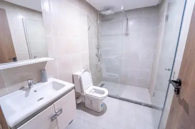 a bathroom with a shower and a toilet and a sink at Modern apartment with pool view Tamaris in Tamaris