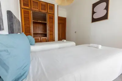two white beds in a room with a window at 3BR Apartment in Prestigious Hay Riad by MERAT HOME in Rabat