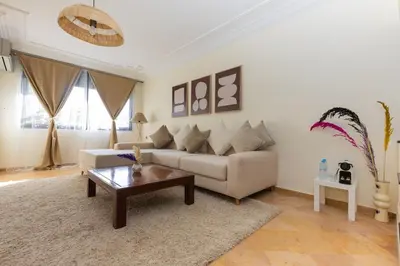 a living room with a couch and a coffee table at 3BR Apartment in Prestigious Hay Riad by MERAT HOME in Rabat