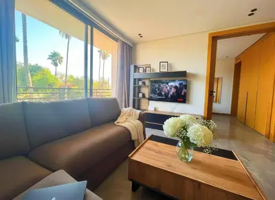 a living room with a couch and a table with flowers at Maya Suites - Opale Sea Side in Anfa-Supérieur
