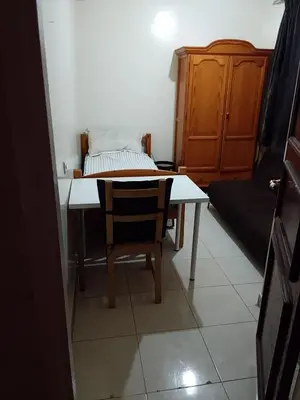 a room with a table and a chair and a bed at Composed of 2 bedrooms and large living room in Casablanca