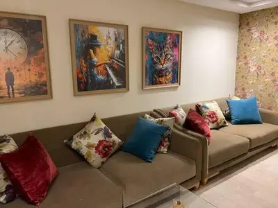 a living room with a couch with colorful pillows at Appartement vue sur le phare in Casablanca