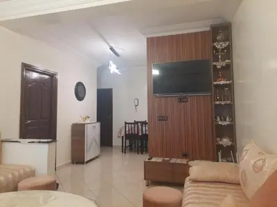 a living room with a couch and a flat screen tv at Kerouch house in Temara