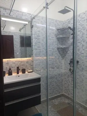a bathroom with a sink and a glass shower at Kerouch house in Temara