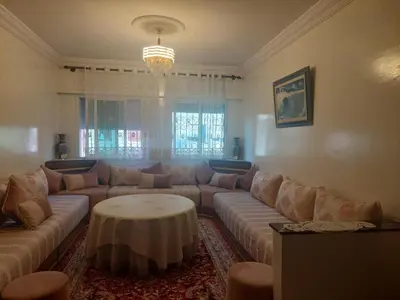 a living room with a couch and a table at Kerouch house in Temara