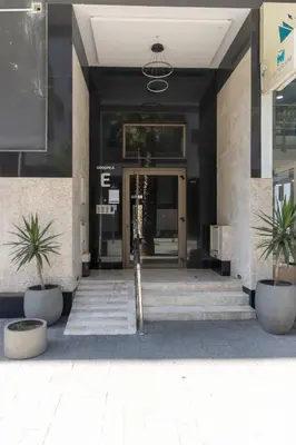 a entrance to a building with two potted plants at Appartement élégant a Parc Mohammedia - proche de la mer in Mohammedia