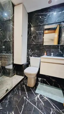 a bathroom with a toilet and a sink and a mirror at Fundays Stay Casablanca in Casablanca