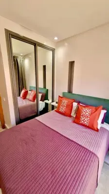 a bedroom with two beds and a large mirror at Fundays Stay Casablanca in Casablanca