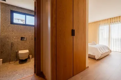 a bedroom with a bed and a bathroom with a toilet at 3BR 3BA Family Apt Pool Gated Residence in Casablanca