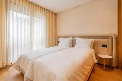 a bedroom with a large white bed with a window at 3BR 3BA Family Apt Pool Gated Residence in Casablanca