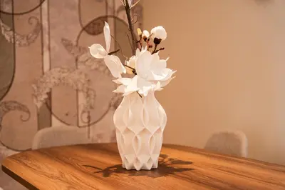 a white vase with flowers in it on a table at 3BR 3BA Family Apt Pool Gated Residence in Casablanca