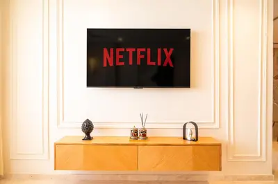 a television on a wall with the netflix sign on it at 3BR 3BA Family Apt Pool Gated Residence in Casablanca