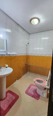a bathroom with a pink toilet and a sink at Privat Room in a Shard Apartment next to MOSQUÉE HASSAN 2 in Casablanca
