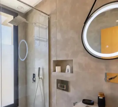 a bathroom with a shower and a mirror at Villa Prestige in Bir Jedíd Saint-Hubert
