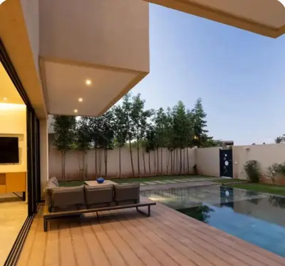 a house with a swimming pool and a patio at Villa Prestige in Bir Jedíd Saint-Hubert