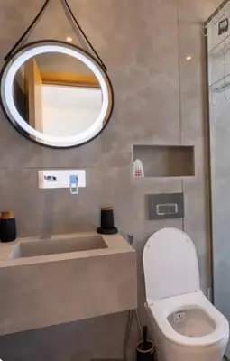 a bathroom with a toilet and a mirror at Villa Prestige in Bir Jedíd Saint-Hubert