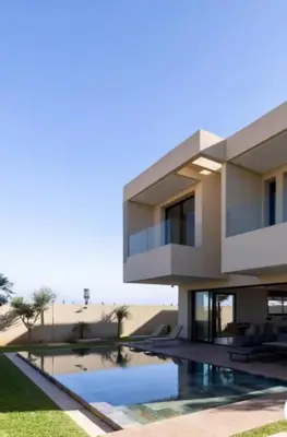 a house with a swimming pool in front of it at Villa Prestige in Bir Jedíd Saint-Hubert