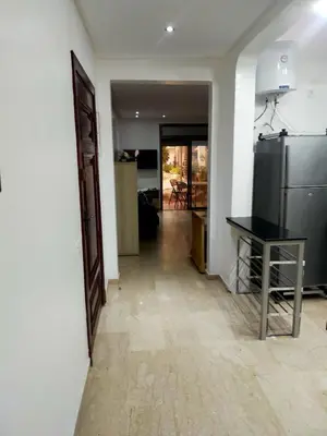 a kitchen with a table and a refrigerator at Modern appt with pool and easy access to beach in Skhirat